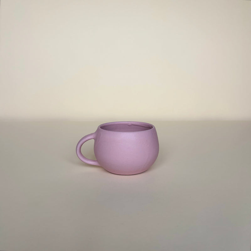 Cute Pink ceramic mug on a beige background. Pottery Mug  Handmade in Ireland. Wheel Thrown Pottery and Ceramic.