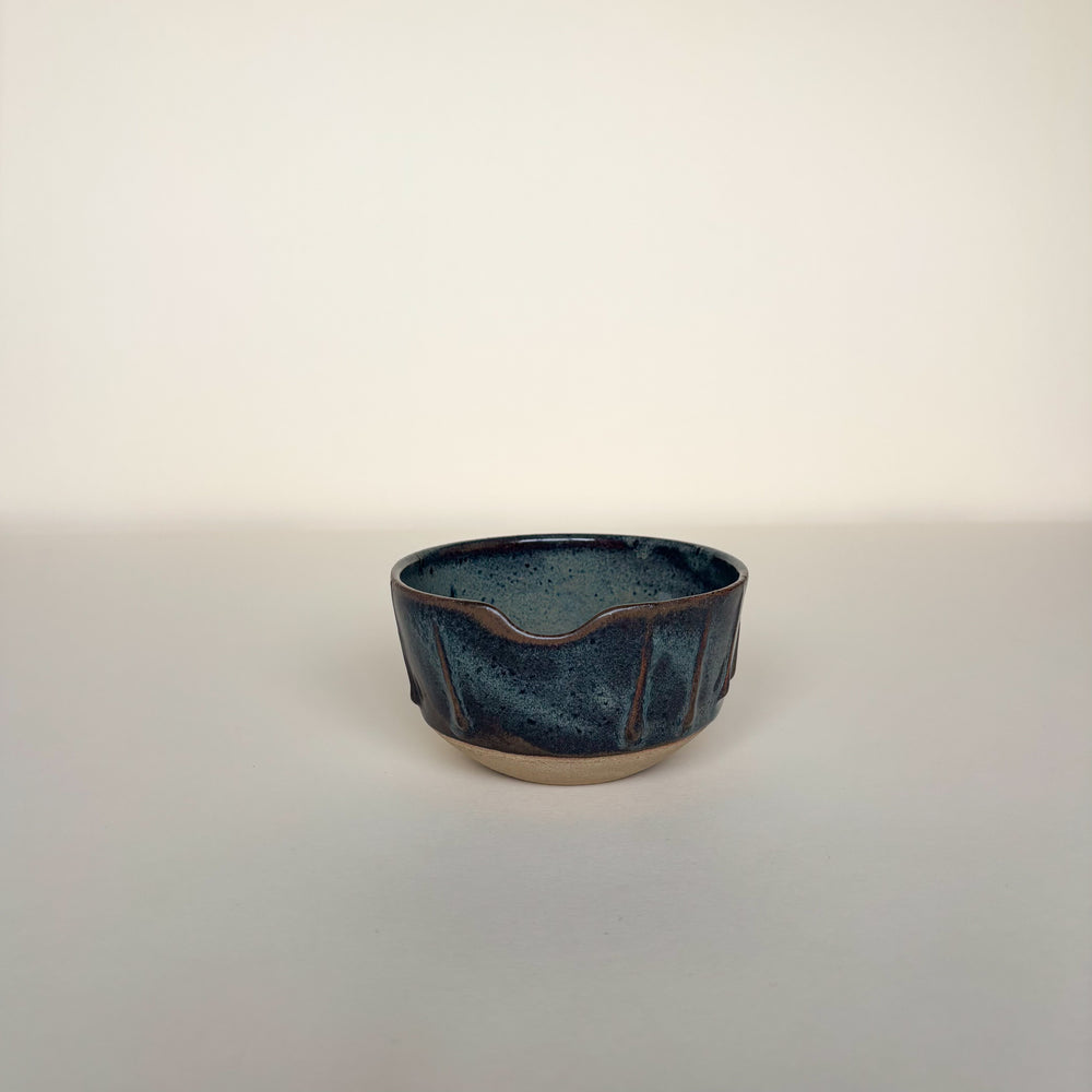 Ceramic bowl with a textured blue glaze on a cream background. Pottery bowl  Handmade in Ireland. Wheel Thrown Pottery and Ceramic. 