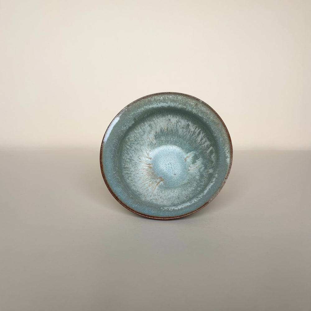 Ceramic dish bowl showing the inside glaze colours on a cream background. Pottery bowl  Handmade in Ireland. Wheel Thrown Pottery and Ceramic. 
