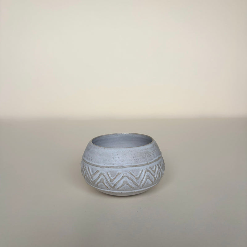 White ceramic pot with a geometric pattern inspired on amazonian marajoara ceramics on a cream background. Pottery pot Handmade in Ireland. Wheel Thrown Pottery and Ceramic. 