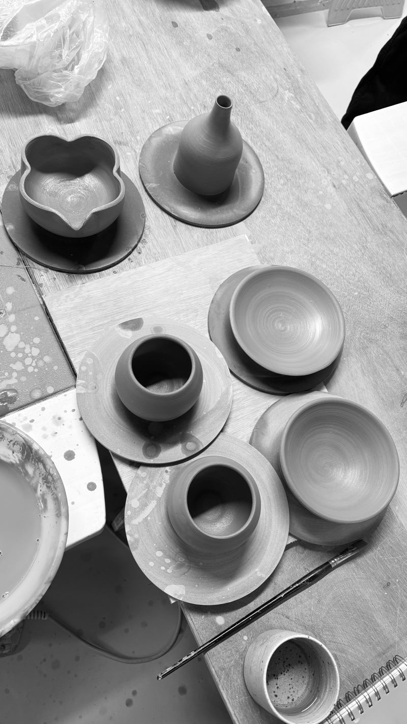 Collection of ceramic pots on a workbench. Handmade Pottery in Ireland, Handmade Ceramic pots.