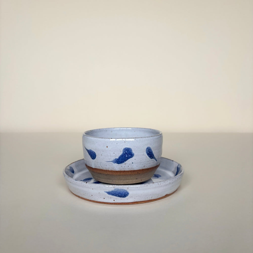 Ceramic bowl and saucer set with abstract blue speckles on a plain cream background. Pottery Handmade in Ireland. Wheel Thrown Pottery and Ceramic. 